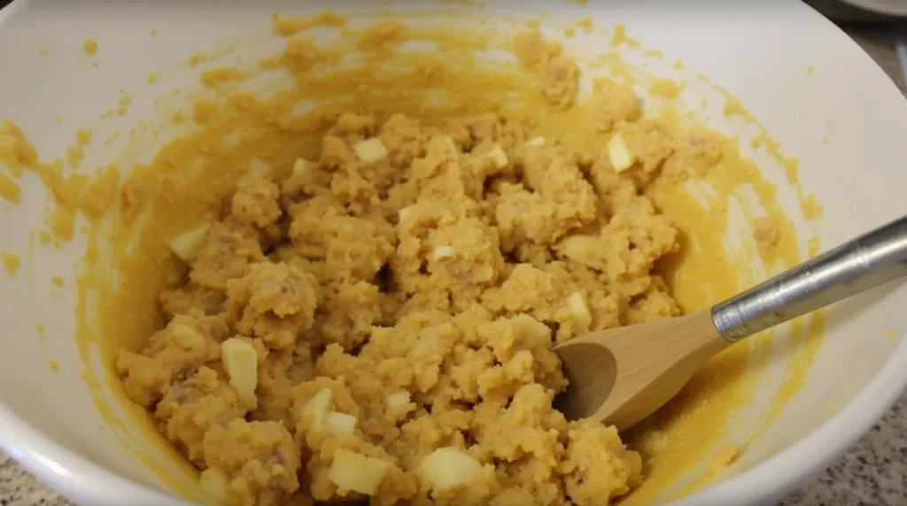 Texas gold bar batter in a bowl with chocolate chips and pecans